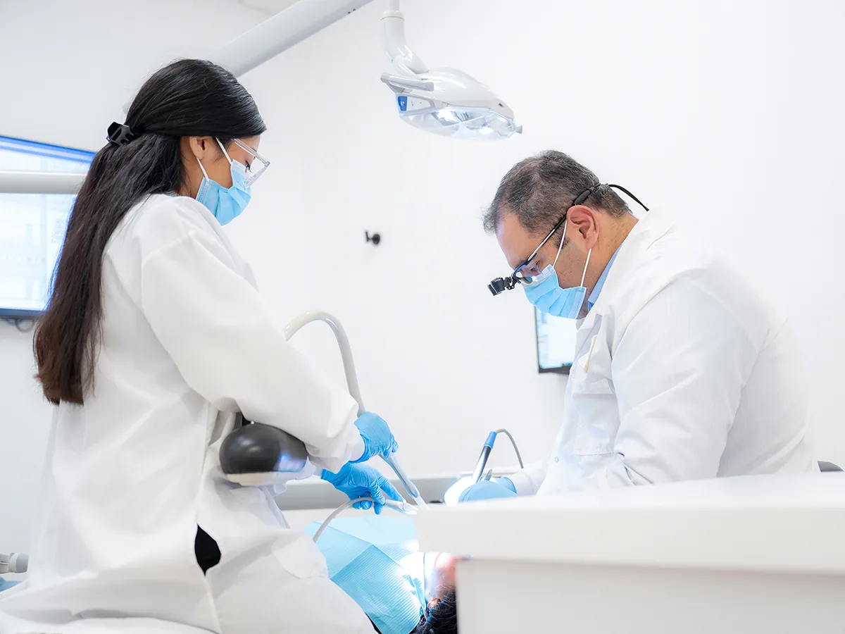 A dentist at All Smiles Dental Studio caring for a patient